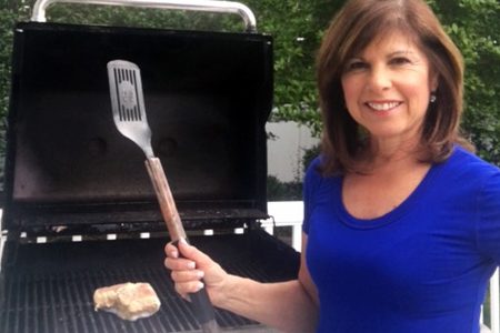 Image of a woman grilling outside